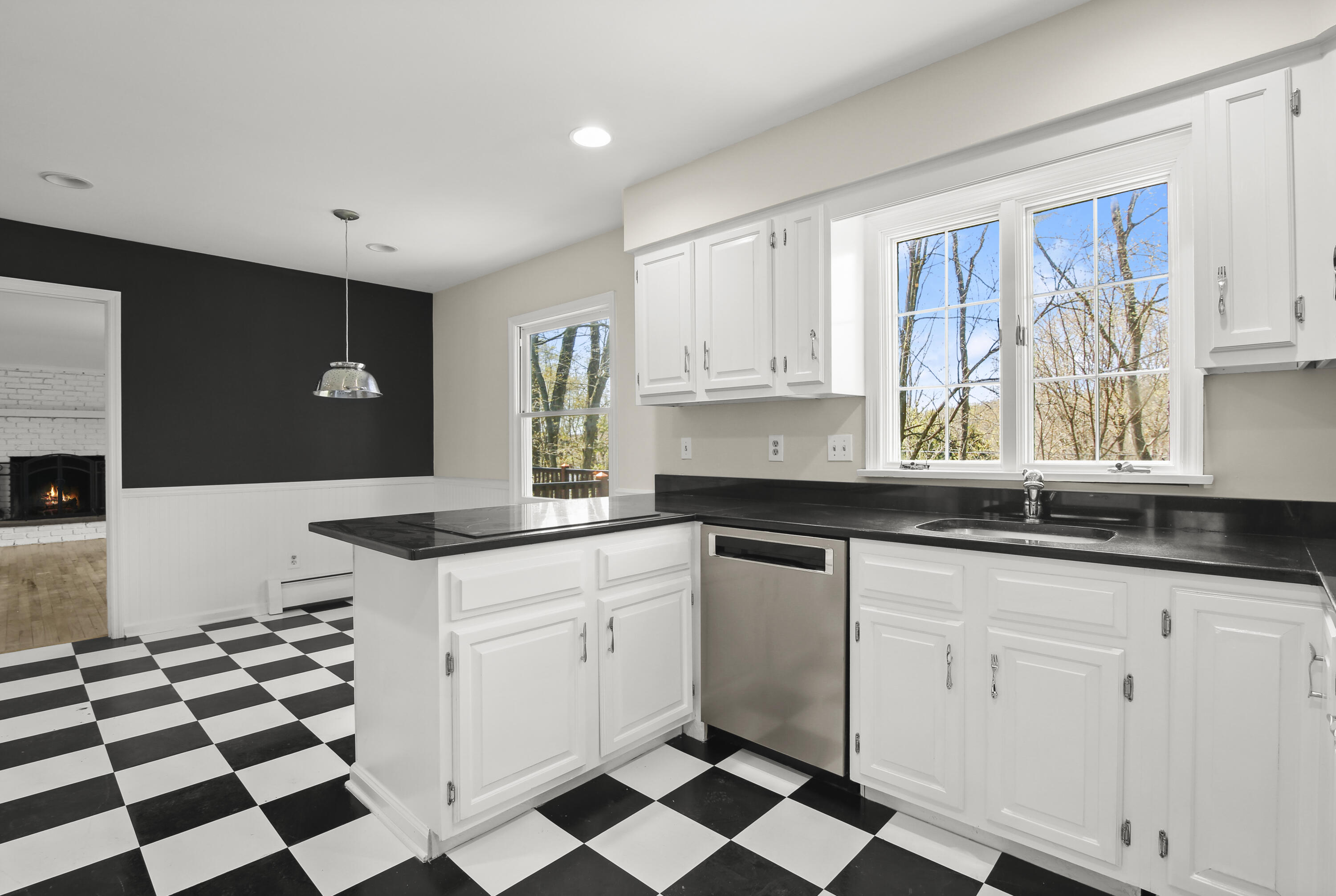 5 Barringer Road Darien, CT 06820 - Photo 10 of 39 a kitchen with granite countertop white cabinets and black stainless steel appliances