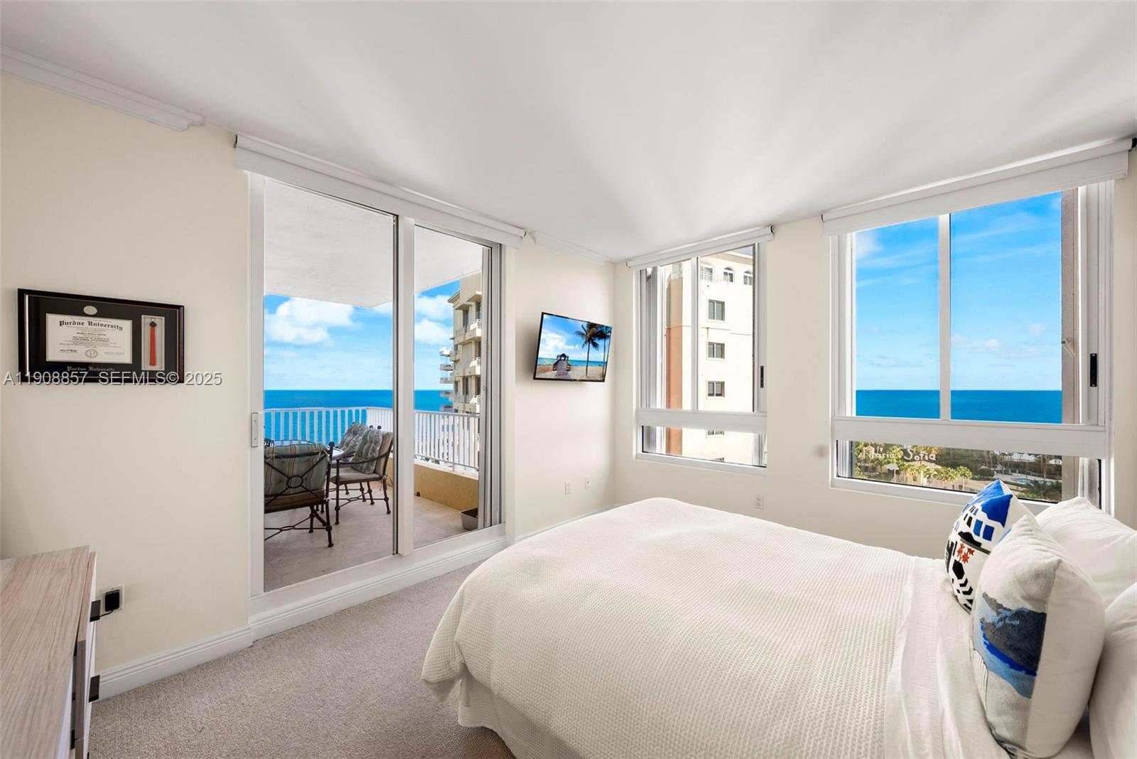 781 Crandon Boulevard, Unit 1406 Key Biscayne, FL 33149 - Photo 12 of 47 a bedroom with a large bed and a large window