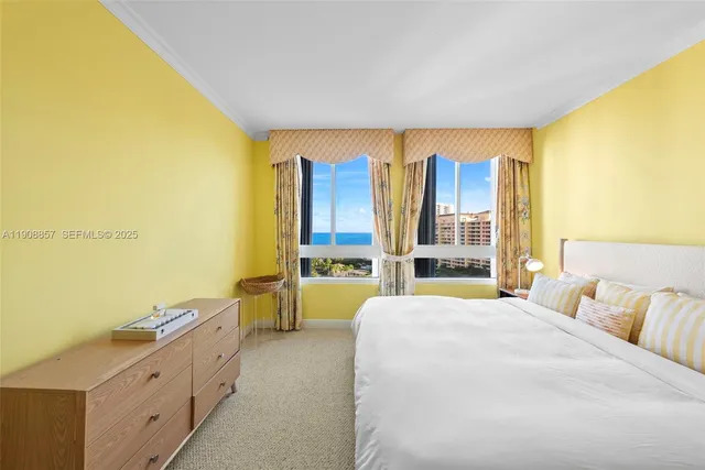 a spacious bedroom with a bed and a large window