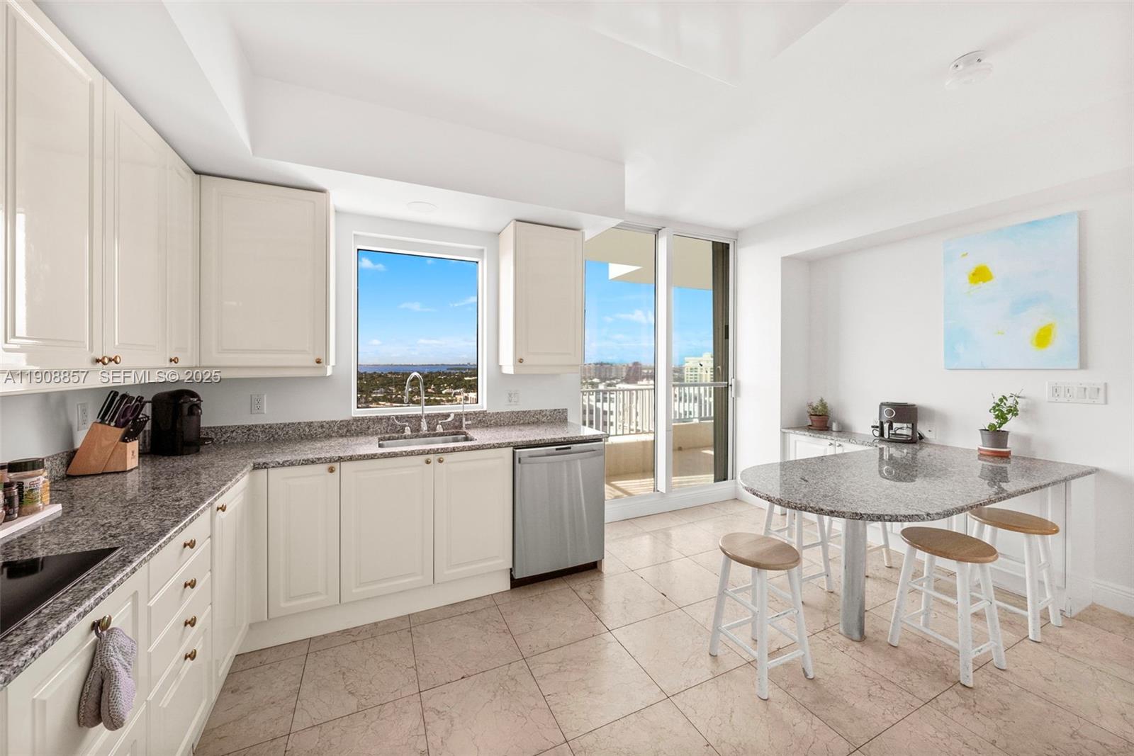 781 Crandon Boulevard, Unit 1406 Key Biscayne, FL 33149 - Photo 15 of 47 a kitchen with a sink and cabinets