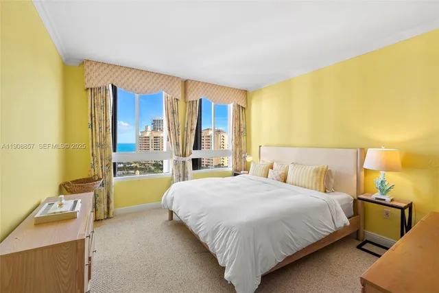 a bedroom with a bed and a dresser next to a blue wall