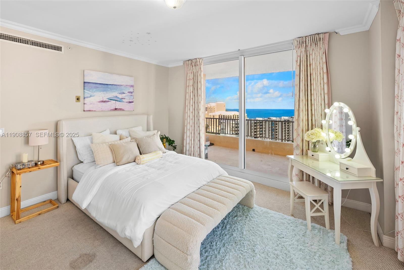 781 Crandon Boulevard, Unit 1406 Key Biscayne, FL 33149 - Photo 17 of 47 a bedroom with a bed and a table