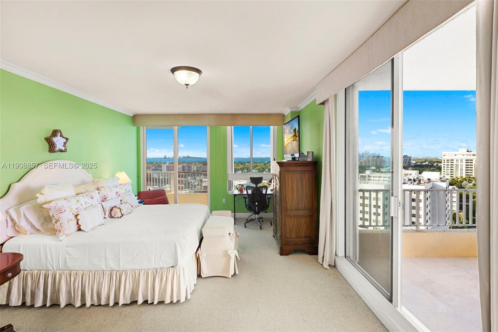 781 Crandon Boulevard, Unit 1406 Key Biscayne, FL 33149 - Photo 22 of 47 a large bedroom with a bed and large window