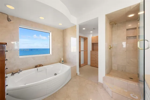 a bathroom with a bathtub and shower