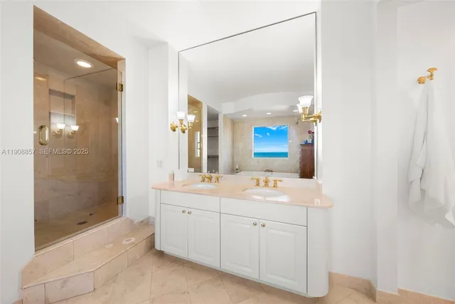 a spacious bathroom with a double vanity sink mirror and shower