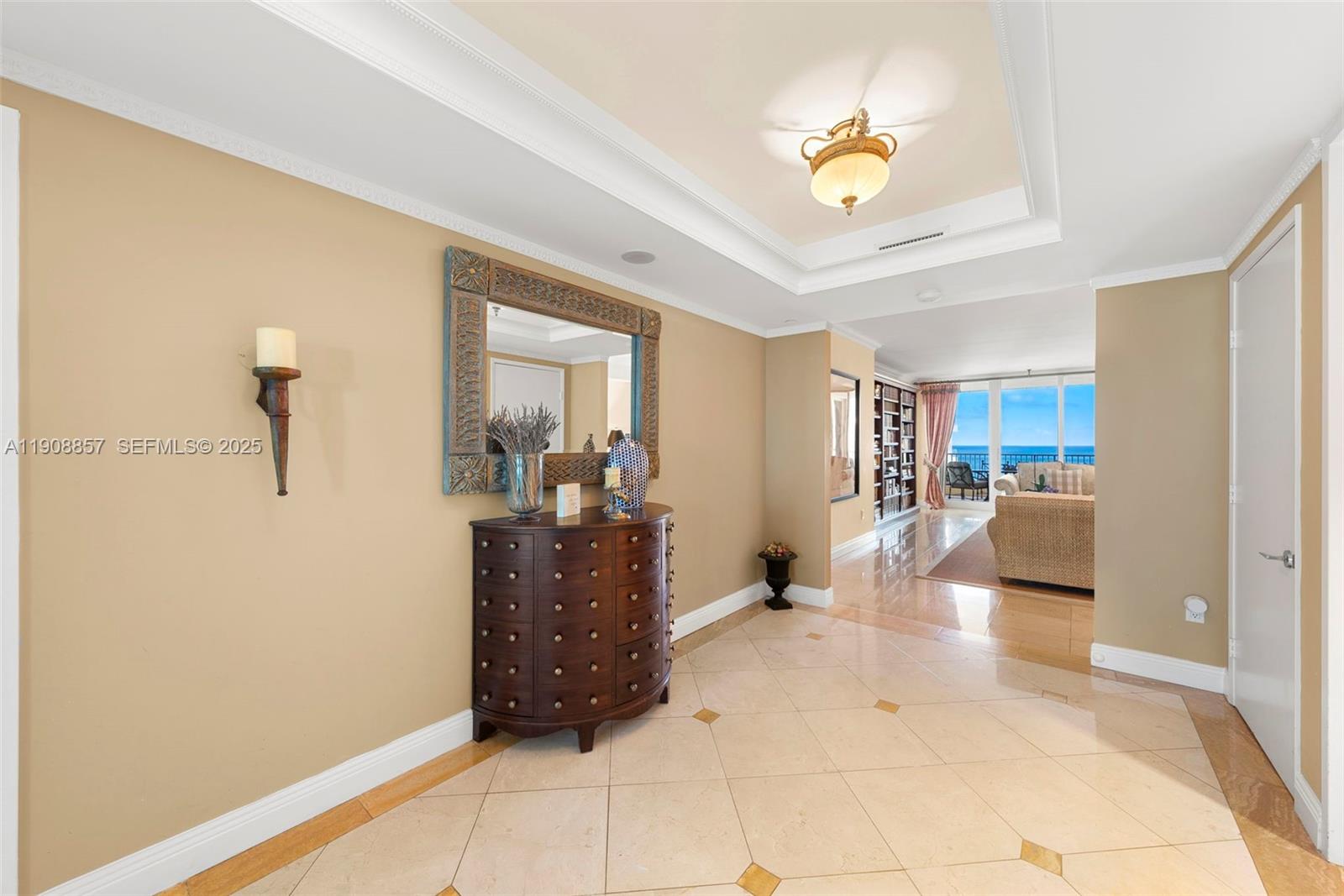 781 Crandon Boulevard, Unit 1406 Key Biscayne, FL 33149 - Photo 4 of 47 a living room with furniture and a chandelier