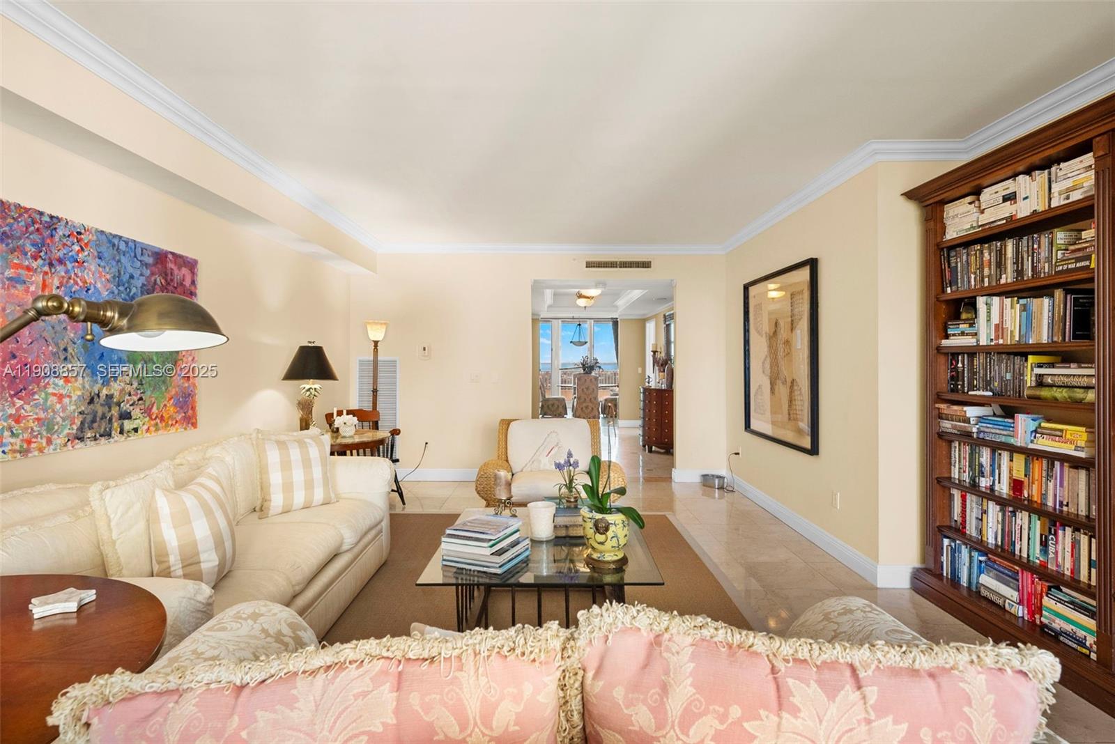 781 Crandon Boulevard, Unit 1406 Key Biscayne, FL 33149 - Photo 6 of 47 a bedroom with a bed and a book shelf