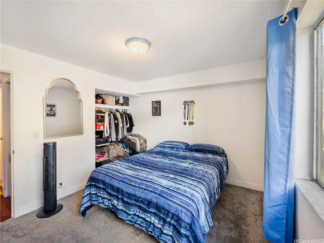 a bedroom with a bed and a closet