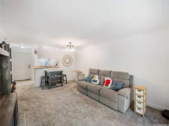 a living room with furniture and a dining table with kitchen view