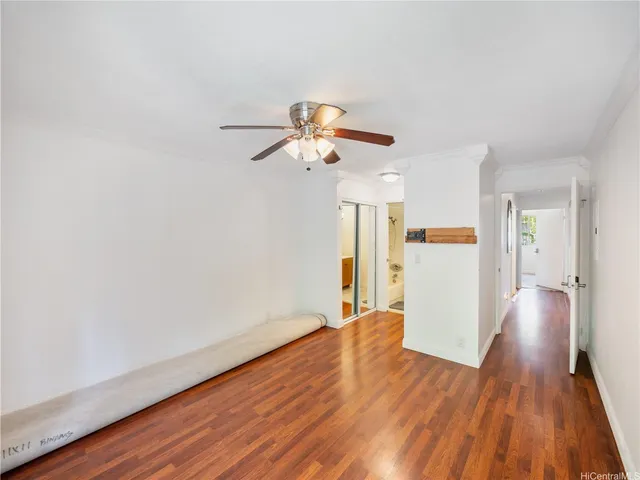 a view of empty room with wooden floor