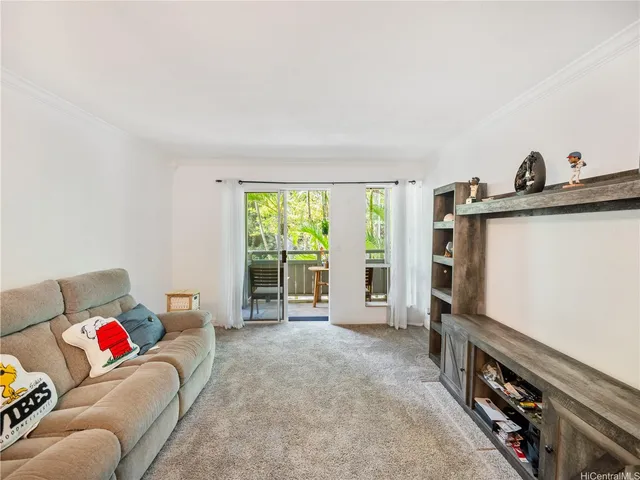 a living room with furniture a flat screen tv and a large window
