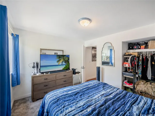 a bedroom with furniture and a flat screen tv