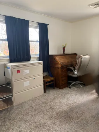 a room that has a dresser and a chair