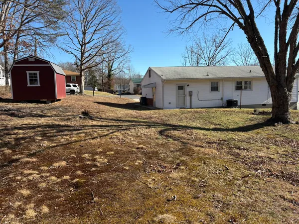 a large house with a large tree in front of a house