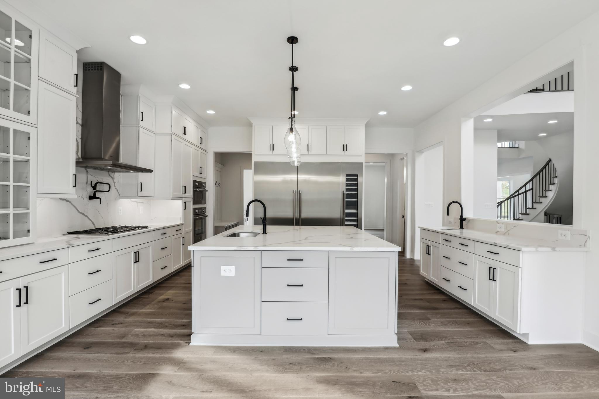 12712 High Meadow Road North Potomac, MD 20878 - Photo 4 of 14 a large kitchen with stainless steel appliances granite countertop a stove oven and a white refrigerator