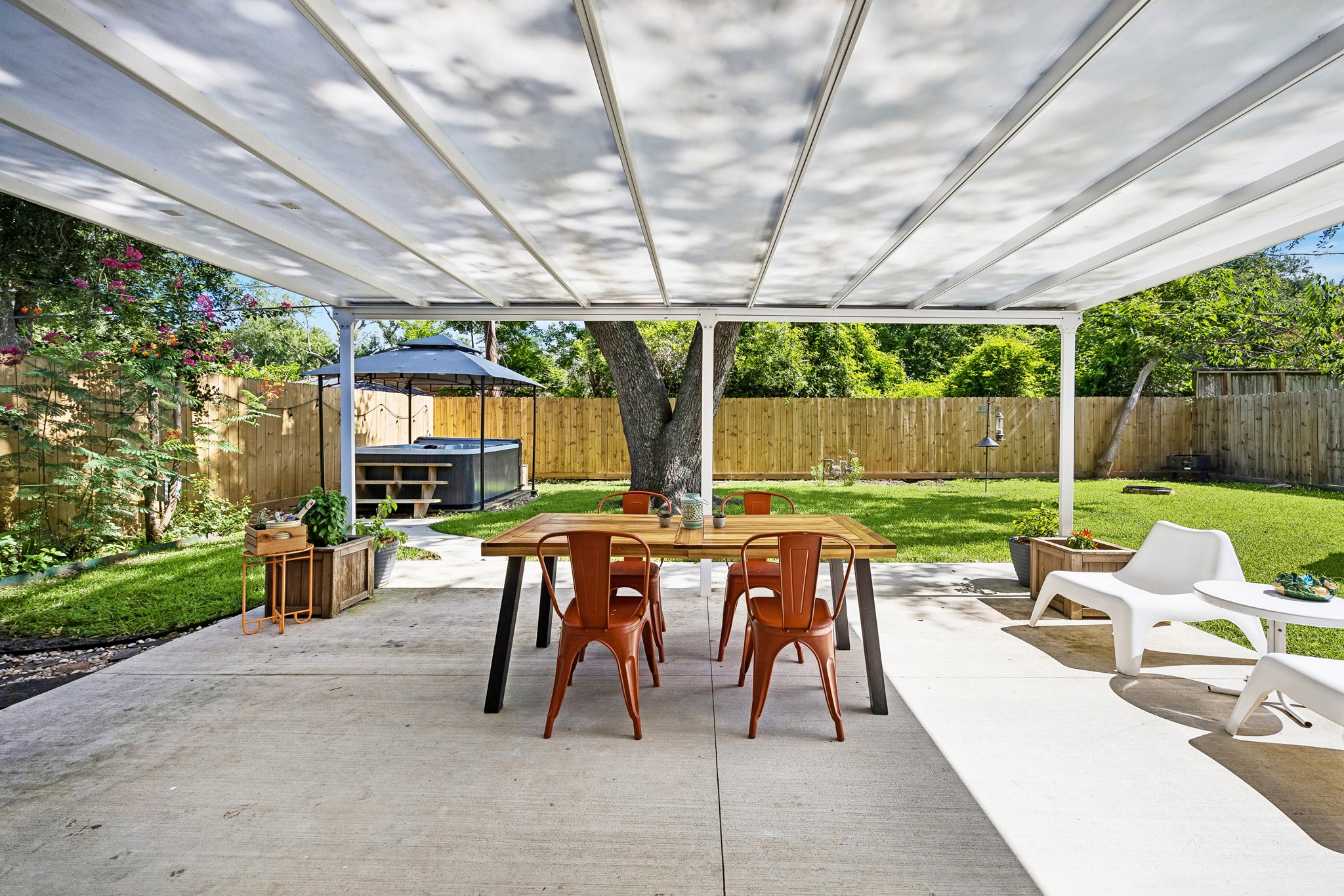 4514 Warm Springs Road Houston, TX 77035 - Photo 27 of 31 The white covered patio allows light to reach the living room. This extension offers indoor outdoor living.