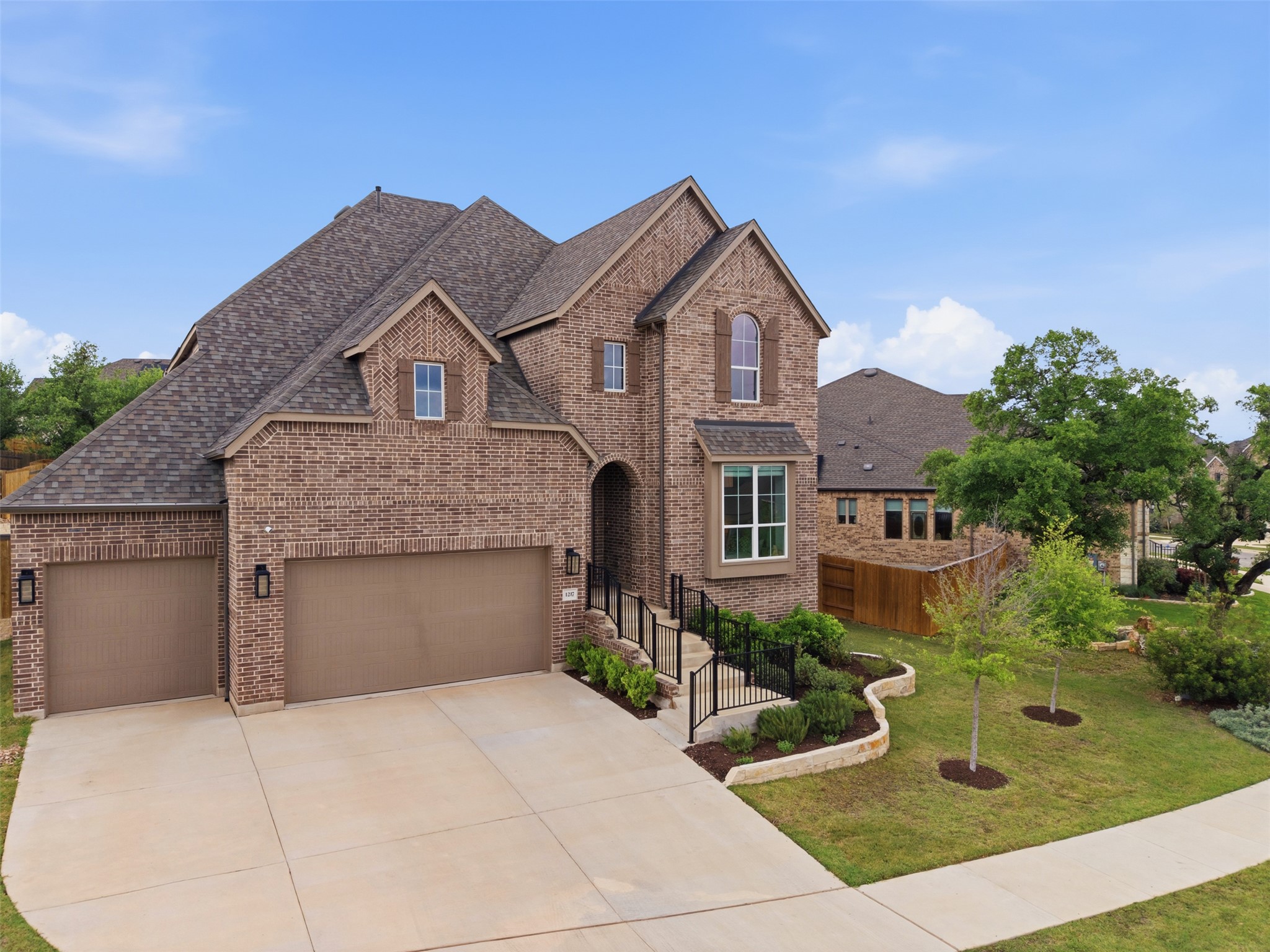 1217 Calendula Trail Georgetown, TX 78628 - Photo 2 of 39 Traditional home with brick siding, driveway, a shingled roof, and a garage