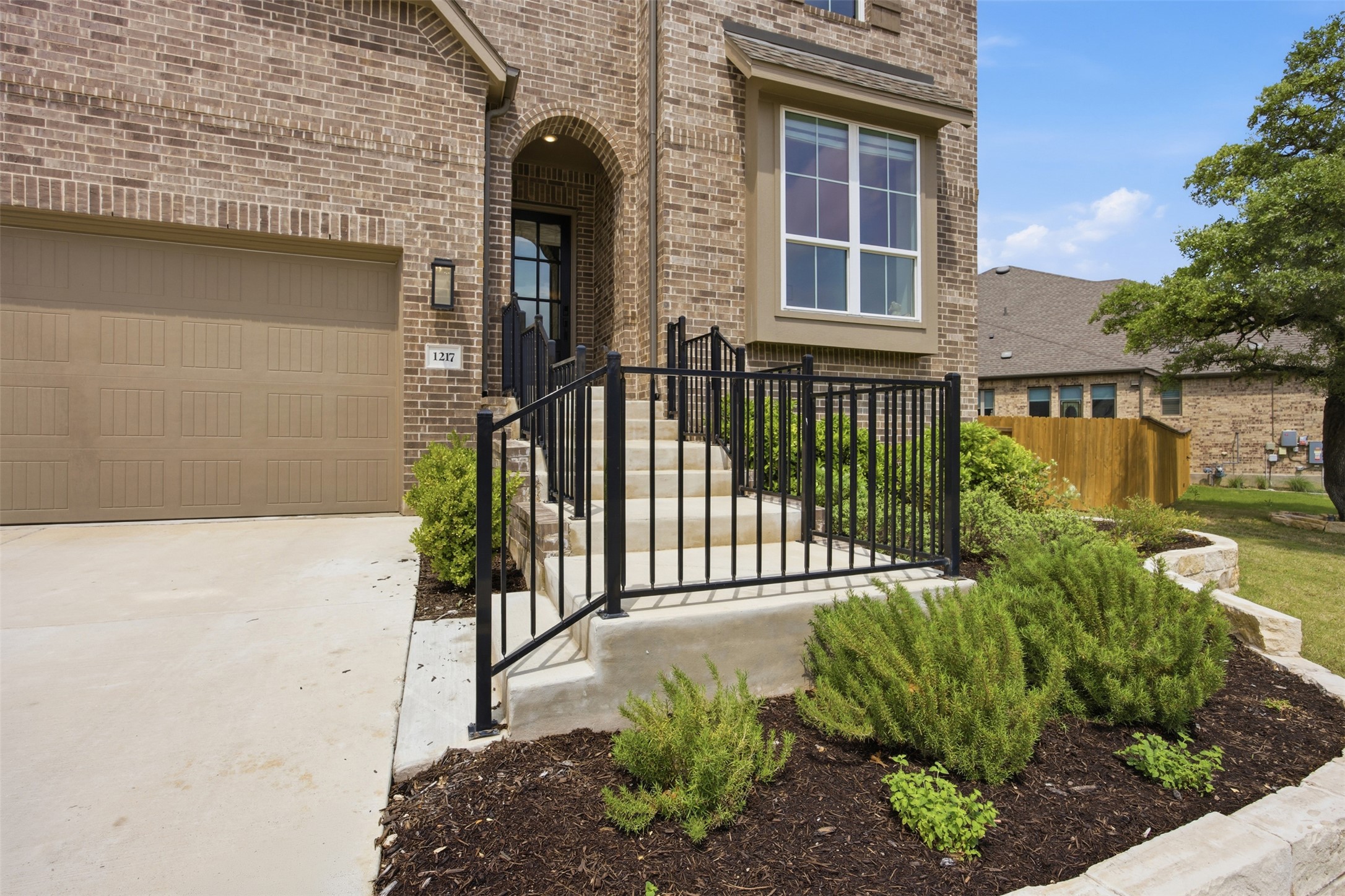 1217 Calendula Trail Georgetown, TX 78628 - Photo 3 of 39 Entrance to property with brick siding, a garage, and concrete driveway