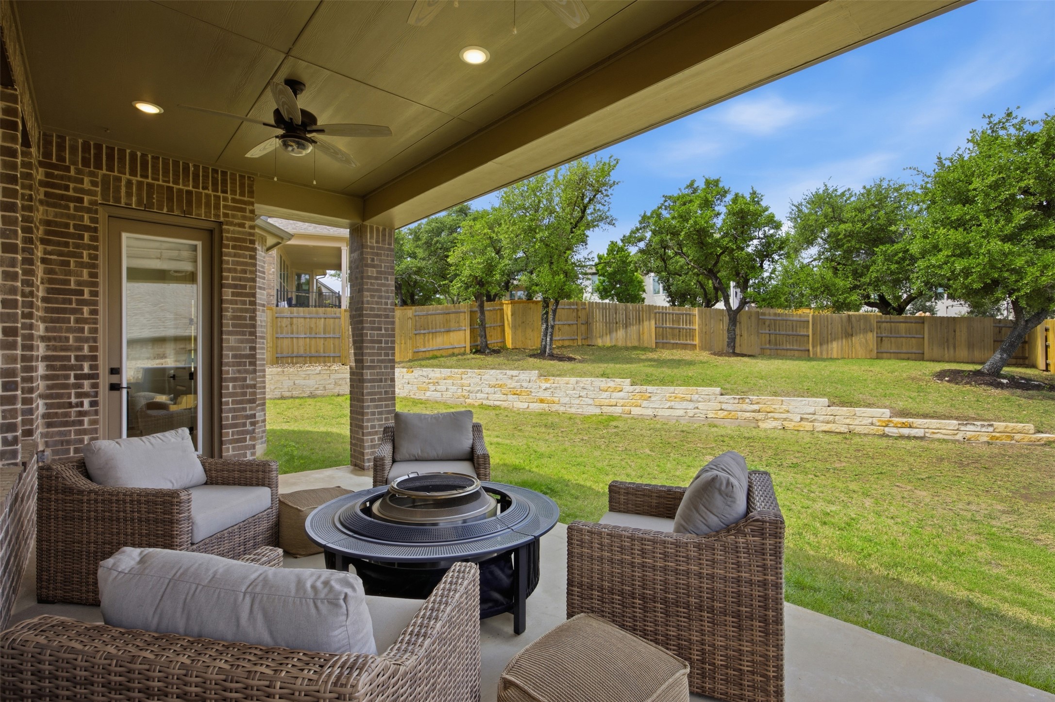 1217 Calendula Trail Georgetown, TX 78628 - Photo 35 of 39 Fenced backyard with a ceiling fan, a patio, and an outdoor living space with a fire pit