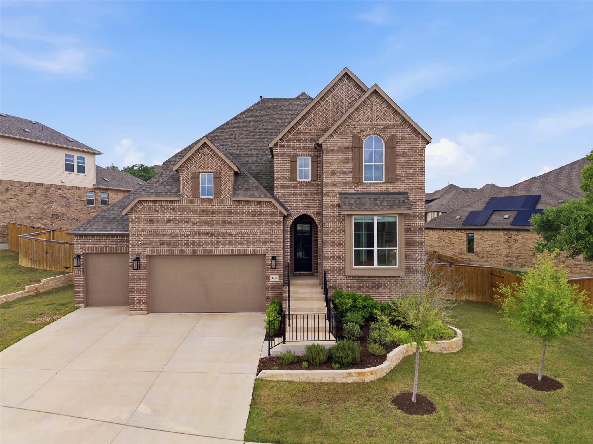 1217 Calendula Trail Georgetown, TX 78628 - Photo 37 of 39 Traditional home featuring brick siding, driveway, an attached garage, and a shingled roof