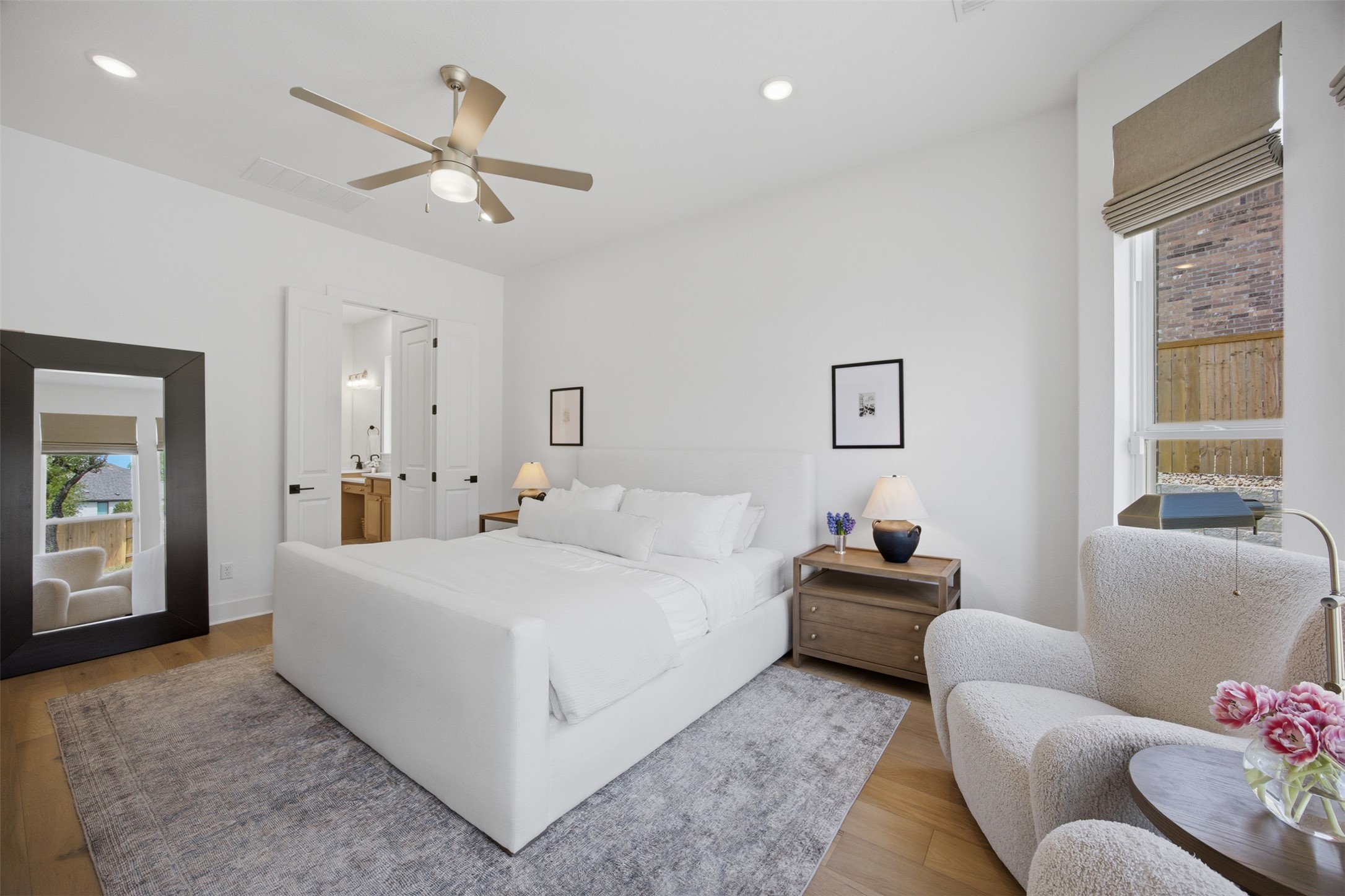 1217 Calendula Trail Georgetown, TX 78628 - Photo 10 of 39 Bedroom featuring wood finished floors, recessed lighting, ceiling fan, and connected bathroom