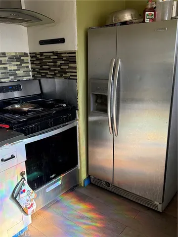 a kitchen with granite countertop a stove and a refrigerator