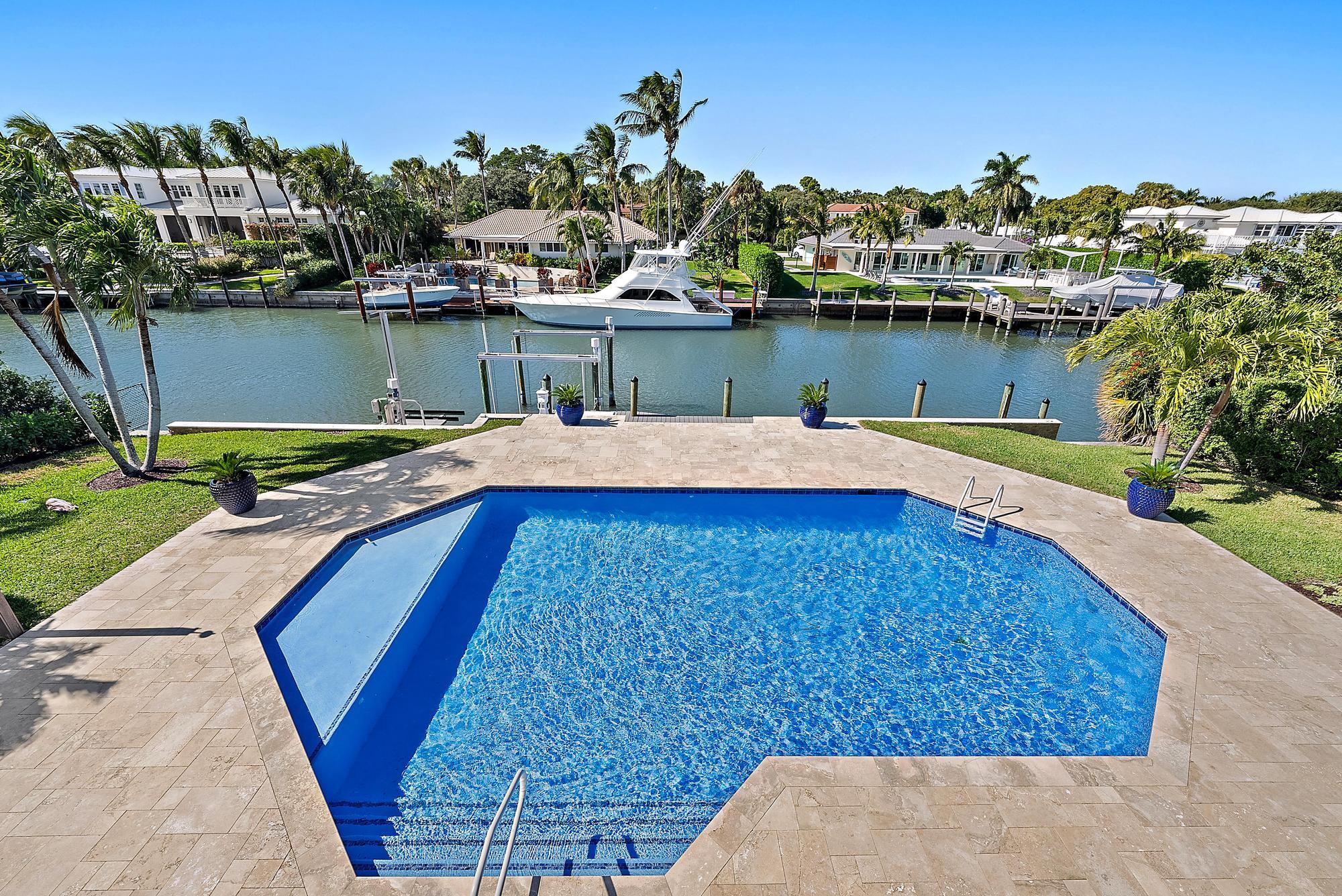 19 Island Road Sewall's Point, FL 34996 - Photo 3 of 50 an aerial view of a house with a yard and lake view