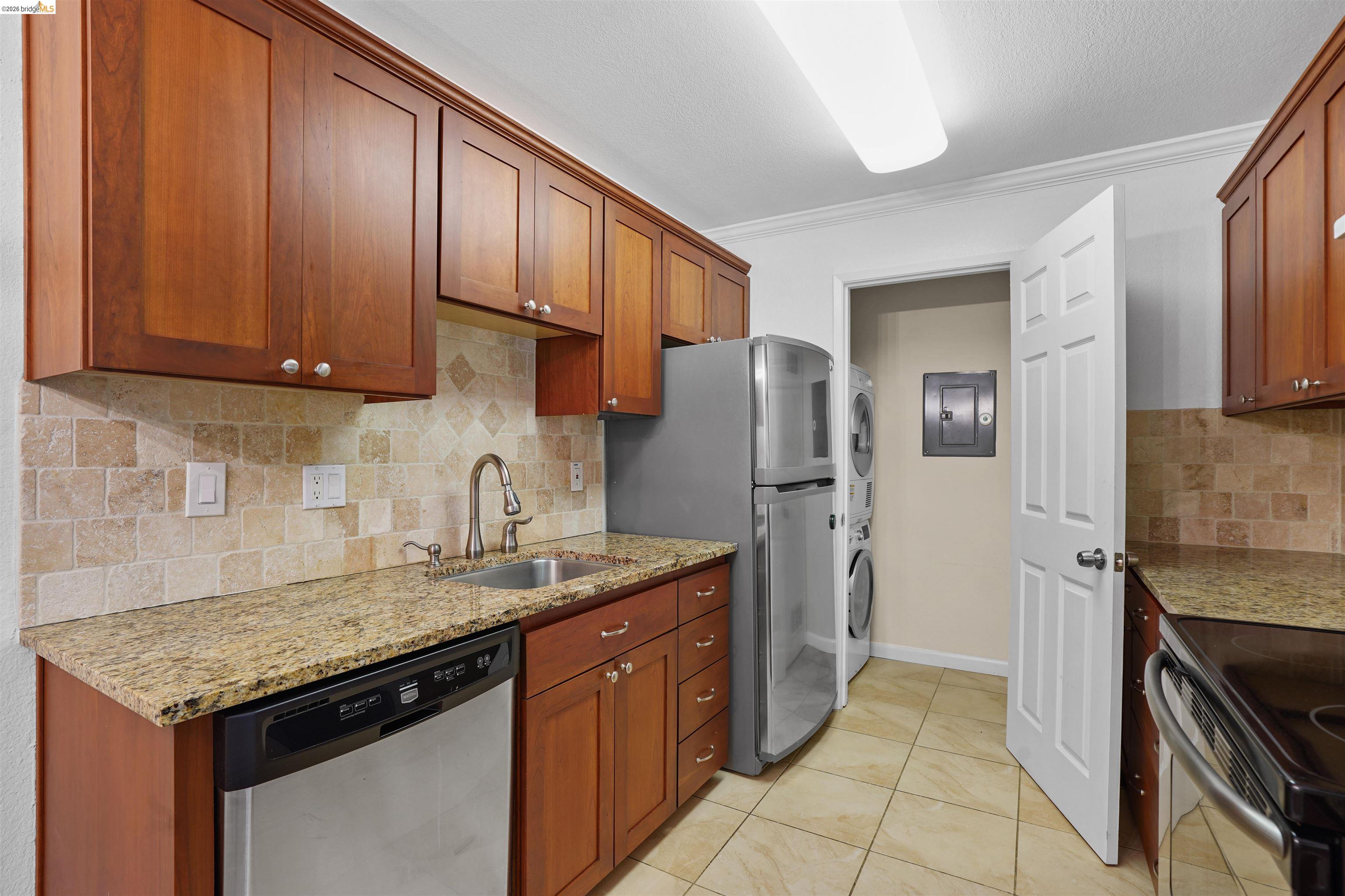 1505 Kirker Pass Road, Unit 214 Concord, CA 94521 - Photo 14 of 55 Kitchen featuring granite countertops, wood-finish cabinetry, stainless steel dishwasher, and a tile backsplash
