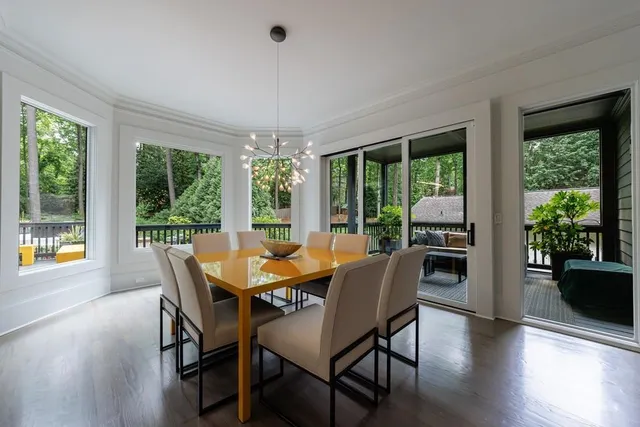 a view of a hallway with wooden floor and windows
