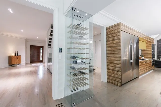 a view of kitchen with kitchen island wooden floor center island and stainless steel appliances