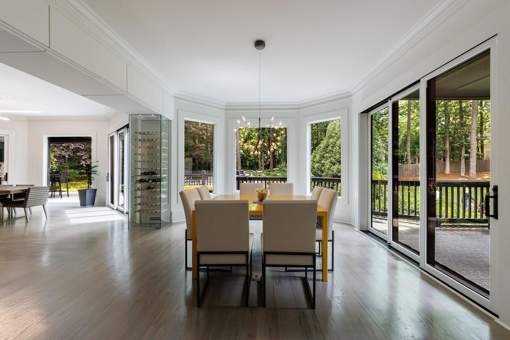3117 West Roxboro Road Northeast Atlanta, GA 30324 - Photo 25 of 78 a view of a dining room with furniture window and wooden floor