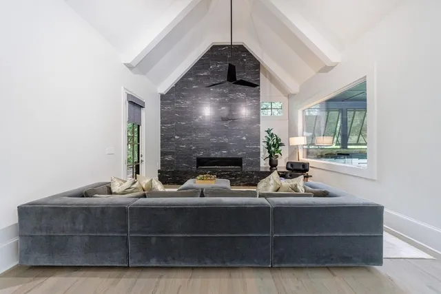 a living room with furniture and a chandelier