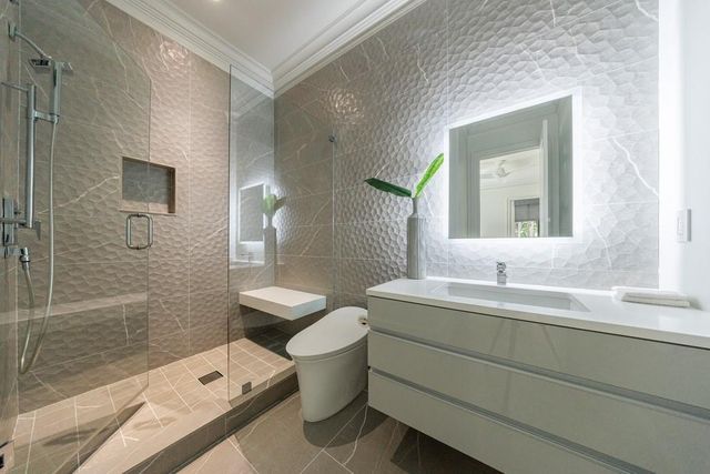 a hallway with sink and mirror