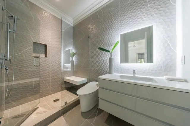 a hallway with sink and mirror