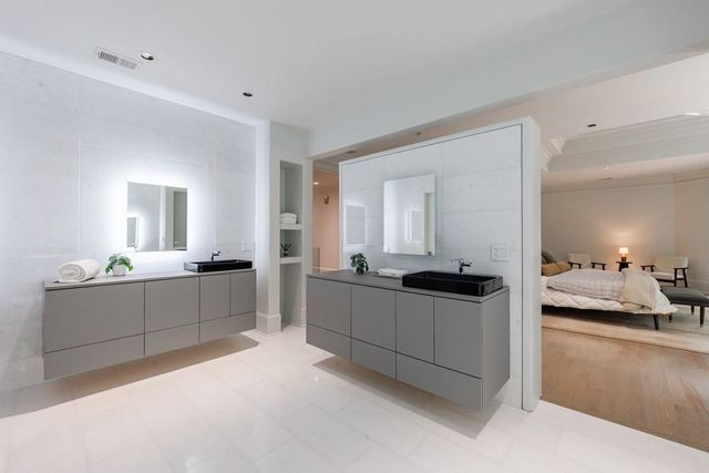 a bathroom with a granite countertop sink toilet and a mirror