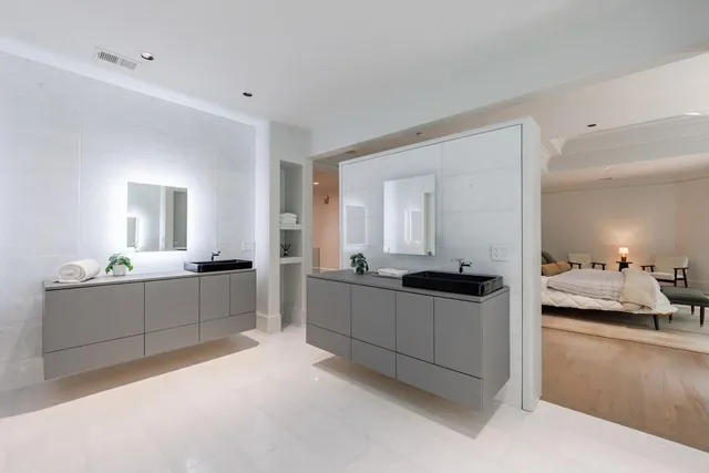 a bathroom with a granite countertop sink toilet and a mirror