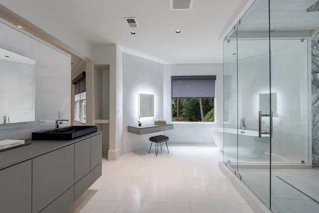 a bathroom with a shower and a glass door