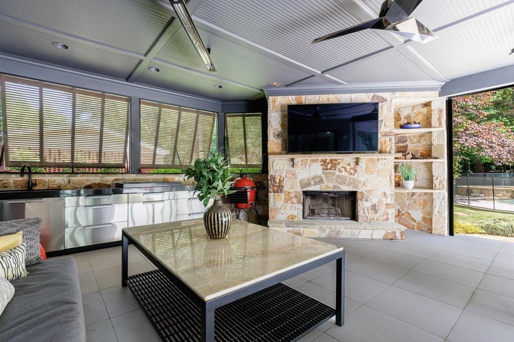3117 West Roxboro Road Northeast Atlanta, GA 30324 - Photo 60 of 78 a living room with furniture a flat screen tv and a fireplace