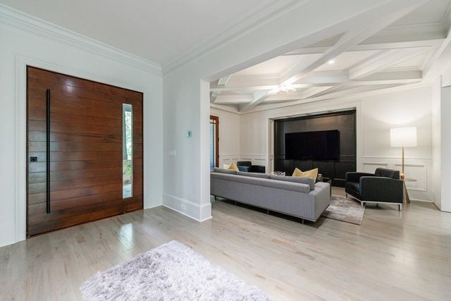 a living room with furniture and large windows