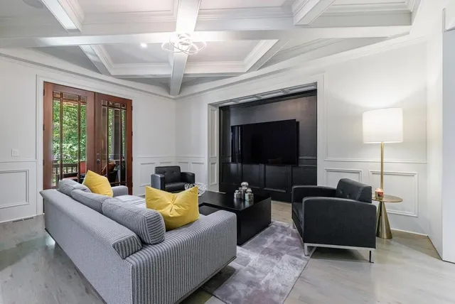 a dining room with furniture a chandelier and wooden floor