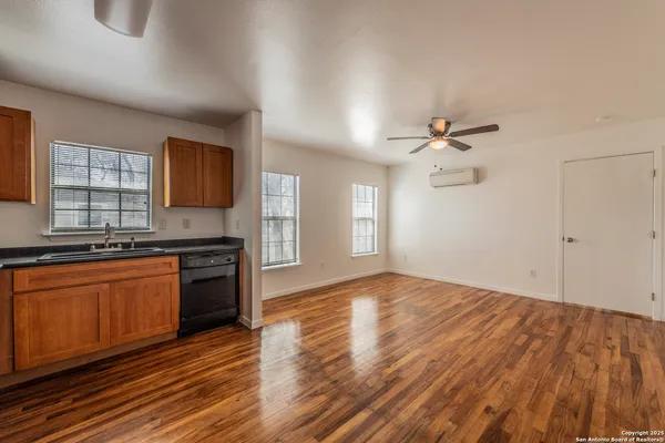 a view of a kitchen with a sink wooden floor and a window