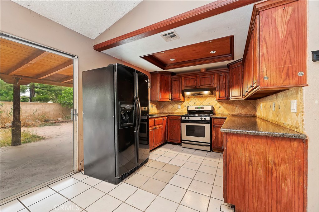 1959 Thornton Street Riverside, CA 92507 - Photo 12 of 26 a kitchen with stainless steel appliances granite countertop a refrigerator and a sink