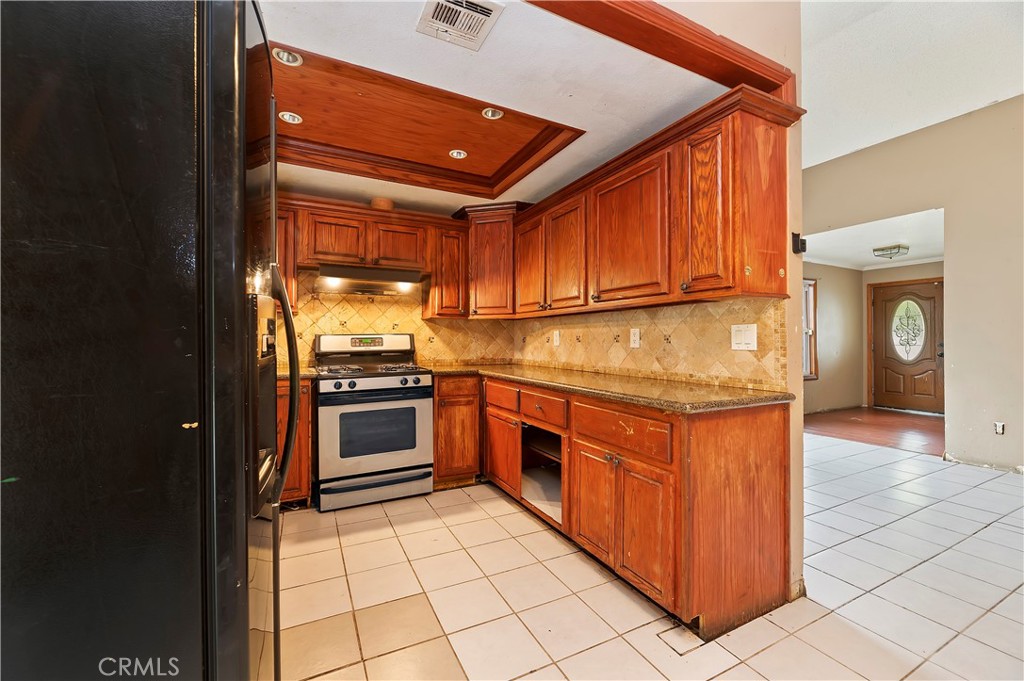 1959 Thornton Street Riverside, CA 92507 - Photo 14 of 26 a kitchen with stainless steel appliances granite countertop a stove a sink and a refrigerator