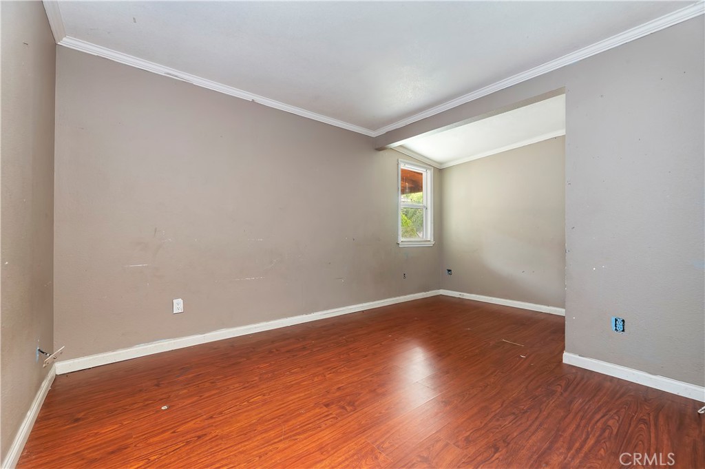 1959 Thornton Street Riverside, CA 92507 - Photo 18 of 26 a view of an empty room with wooden floor and a window