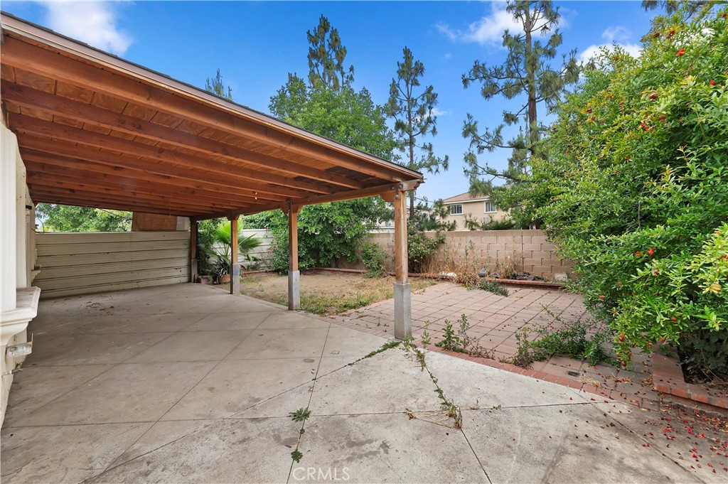 1959 Thornton Street Riverside, CA 92507 - Photo 22 of 26 a backyard of a house with table and chairs under an umbrella