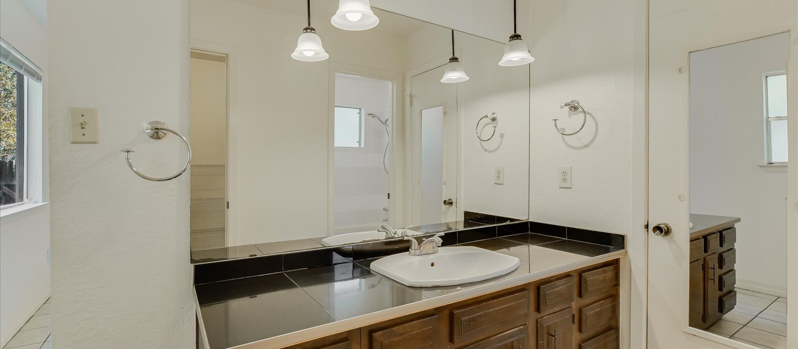 3908 Holt Drive Austin, TX 78749 - Photo 12 of 21 a bathroom with a sink a mirror and a shower