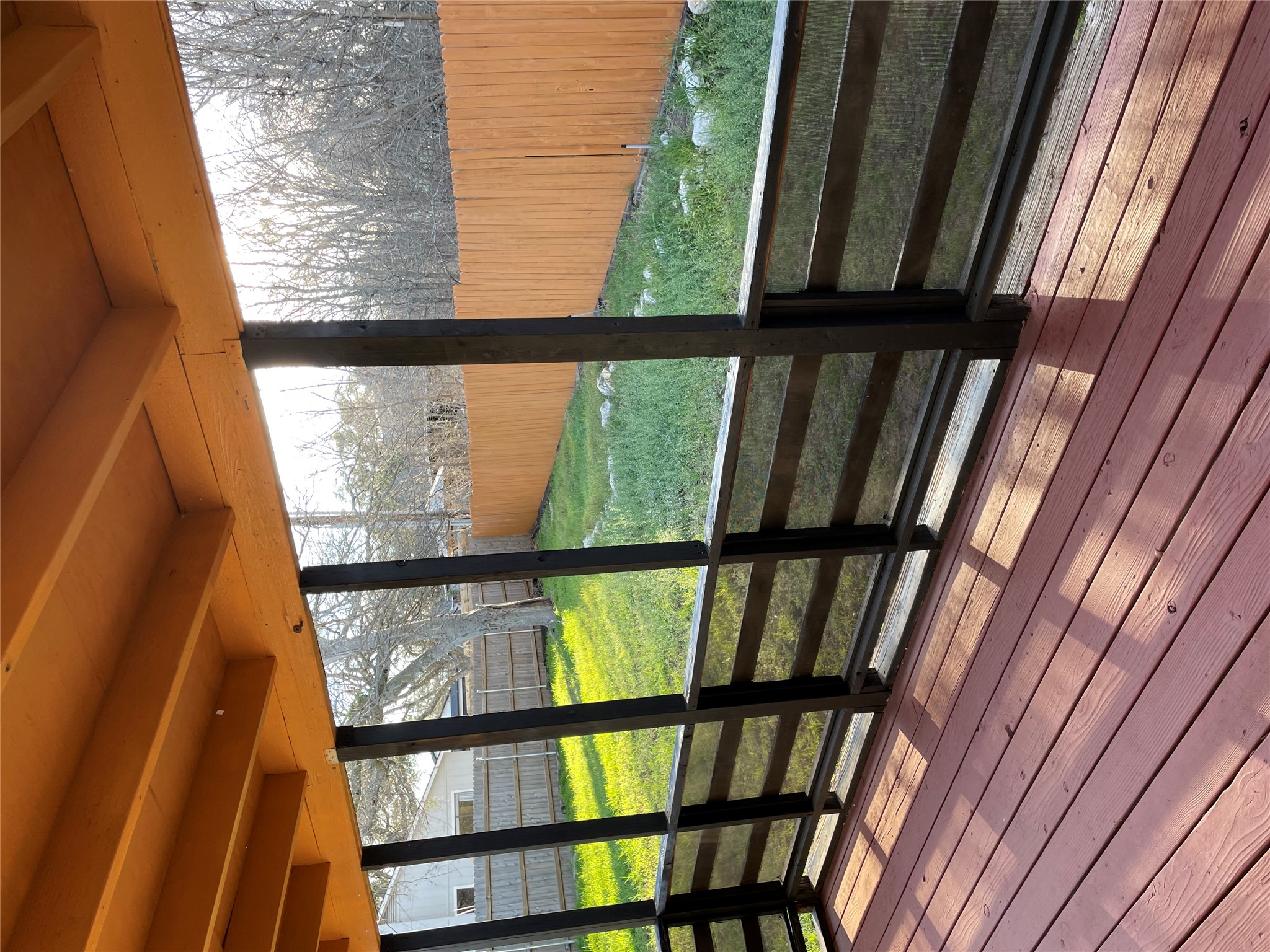 3908 Holt Drive Austin, TX 78749 - Photo 22 of 22 Spacious sunroom featuring a deck and beamed ceiling