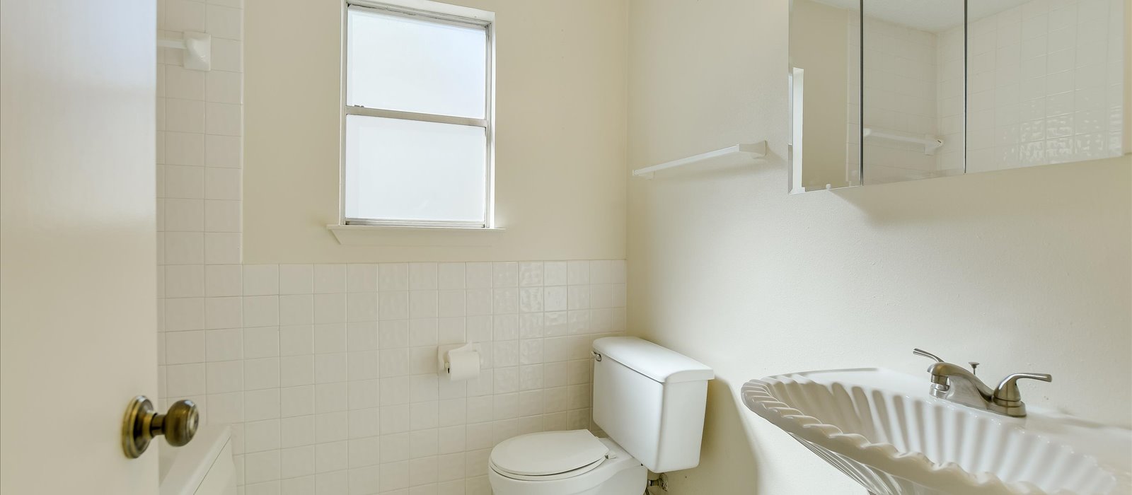 3908 Holt Drive Austin, TX 78749 - Photo 5 of 22 Spacious secondary bathroom with pedestal sink, shower/tub combination and natural lighting