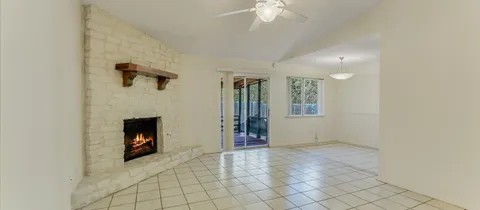 wooden floor in an empty room with a fireplace