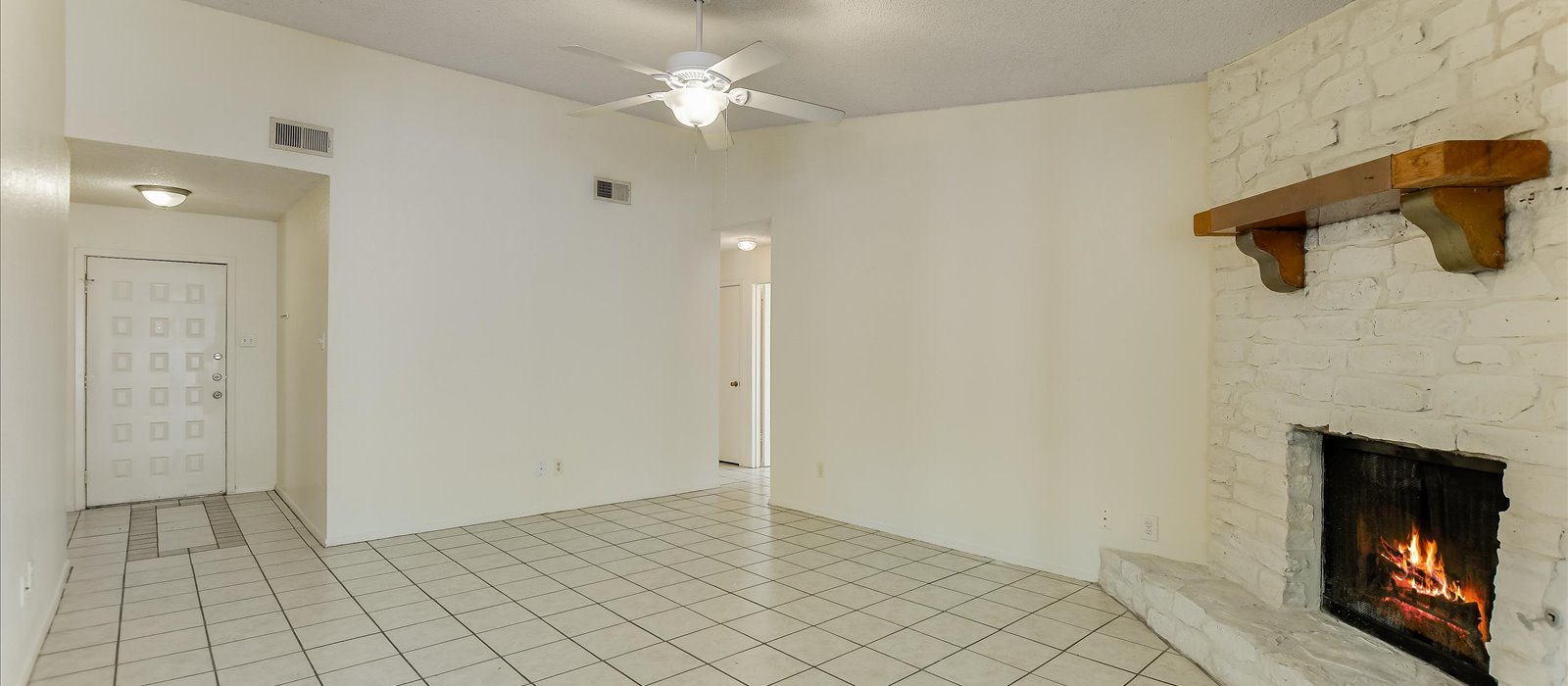 3908 Holt Drive Austin, TX 78749 - Photo 6 of 21 wooden floor in an empty room with a fireplace